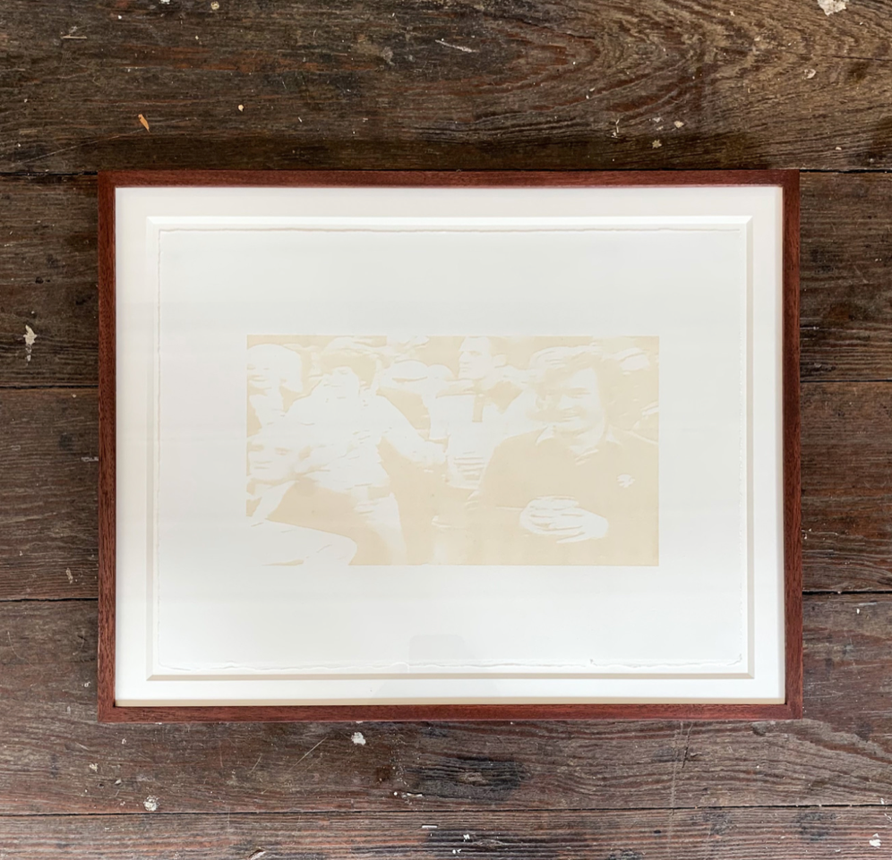 Framed artwork on a wooden surface