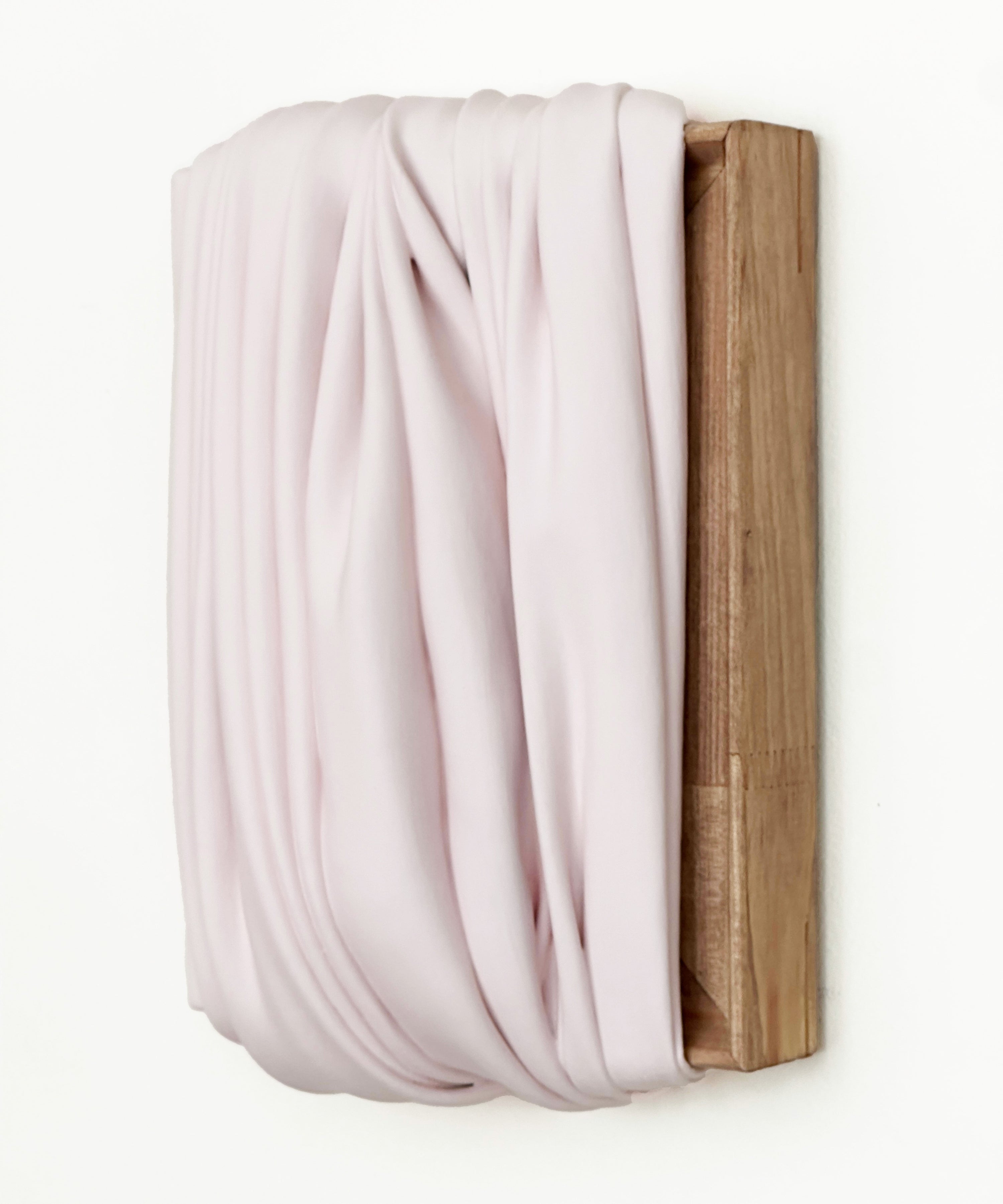 White paint skin pleated on stretcher, draped over a wooden frame on a white background